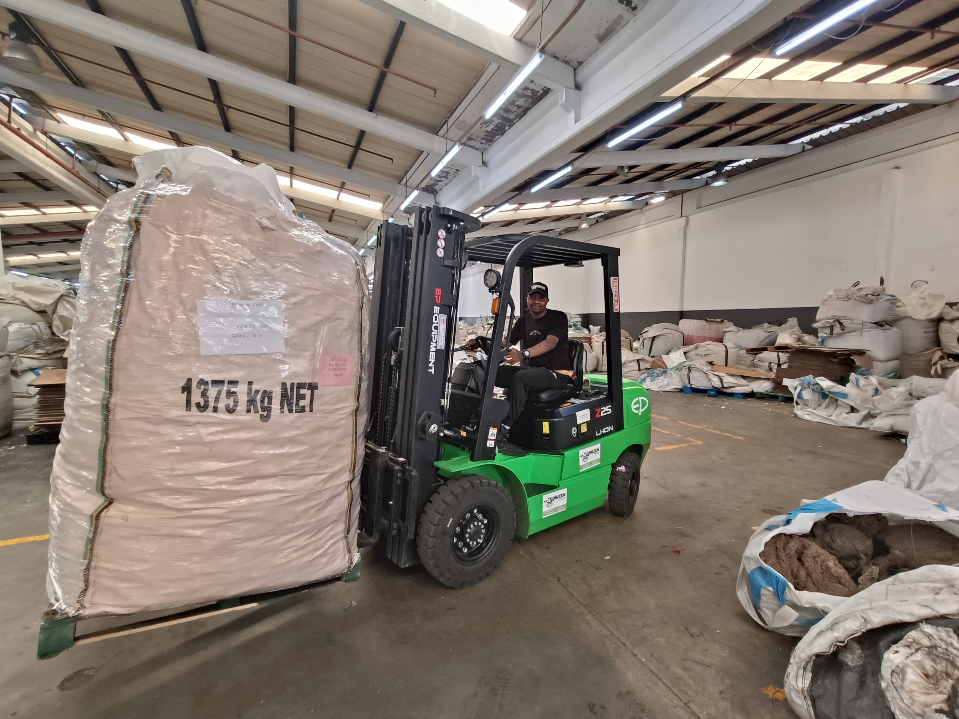 Forklift moving baled material